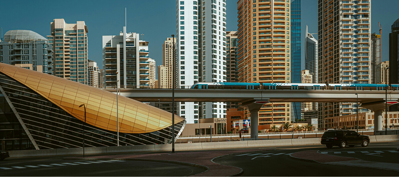 Dubai Metro station with its golden shell roof beside Marina towers