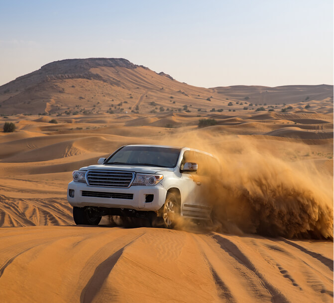 4x4 driving over desert dunes
