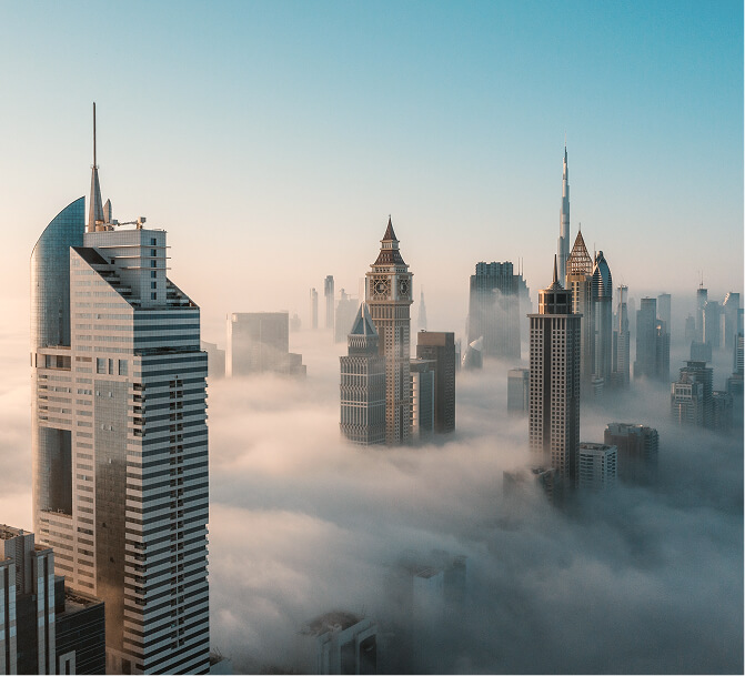 Dubai skyscrapers rising above morning fog