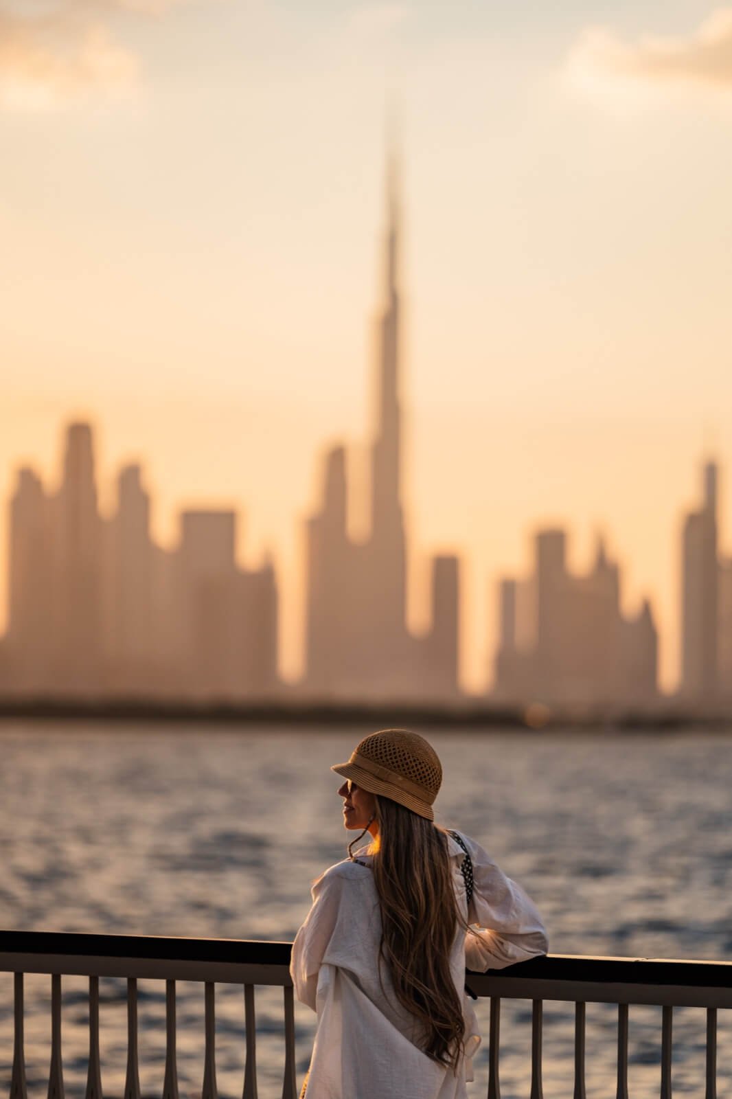 Traveller overlooking the Dubai skyline at sunset