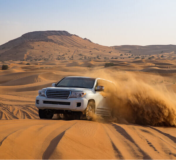 4x4 driving over desert dunes
