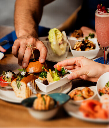 Friends sharing plates and drinks at JamJars, Dubai Marina